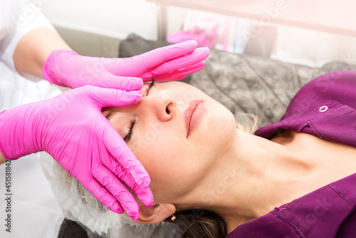 Beautiful girl has a facial massage in a beauty clinic