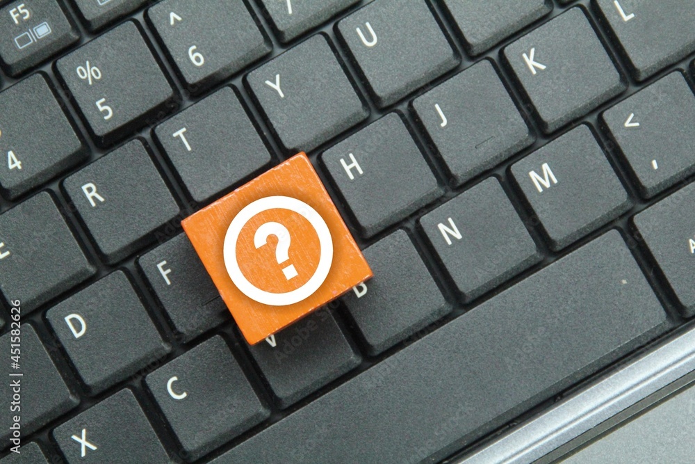 laptop keyboard, colored cubes with query icons. Question mark concept laptop keyboard, colored cubes with query icons. Question mark concept