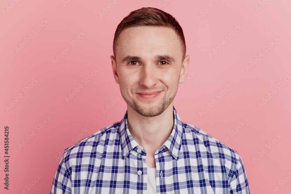 Obraz premium Close-up portrait of young handsome guy happy positive smile isolated over pink color pastel background