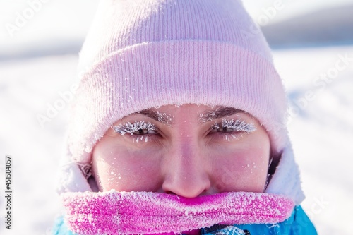 woman with frost eyelashes on a frosty winter day, outdoors