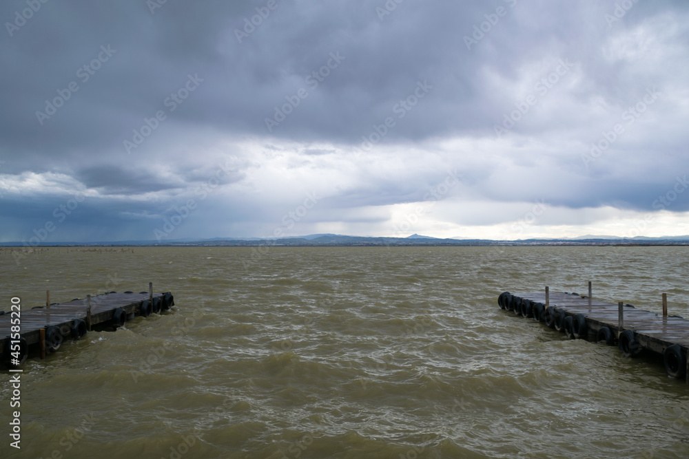 La Albufera piers on a stormy afternoon with rough water. Valencia - Spain La Albufera piers on a stormy afternoon with rough water. Valencia - Spain