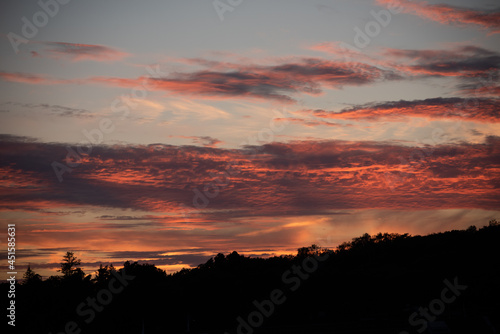 Red clouds lit up by the sun at sunset.