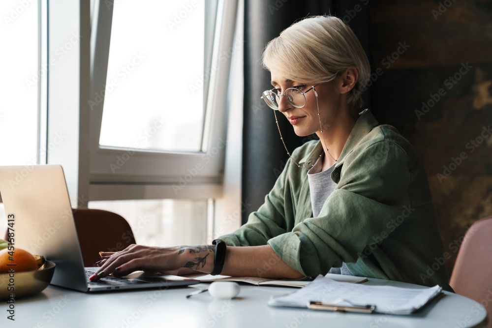Middle aged blonde woman with short hair studying Middle aged blonde woman with short hair studying