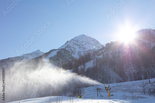 the snow cannon inflates the snow in the early morning. snow generator at a ski resort