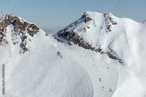 panorama of the perfect ski slope. a ski resort high in the mountains after a big snowfall. prepared track for snowboarding and skiing photo