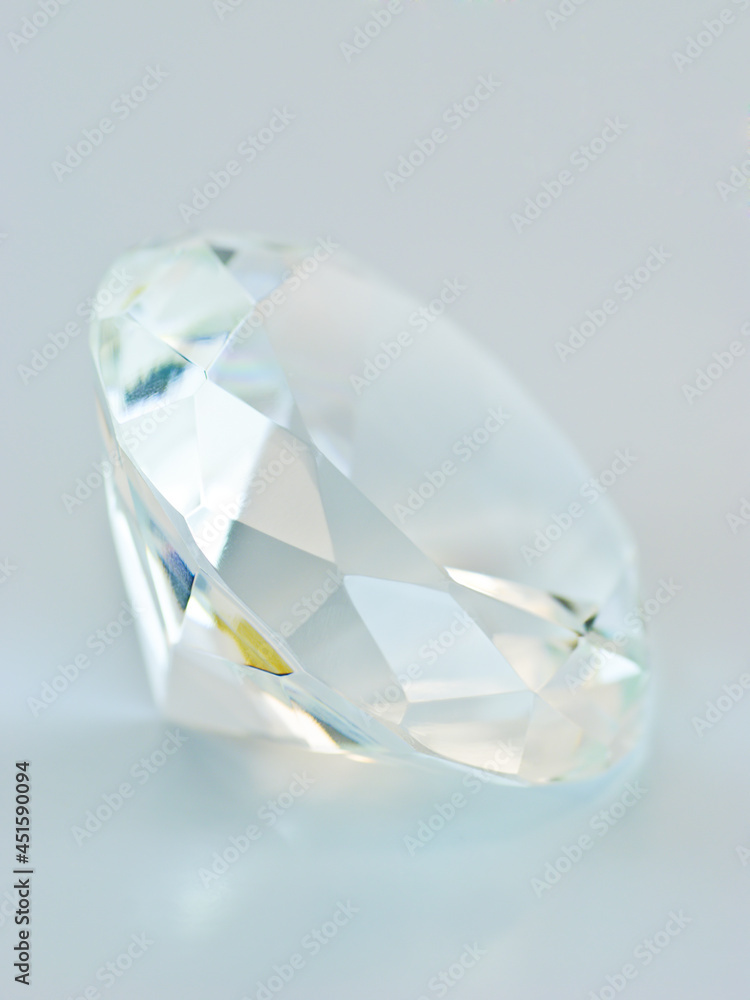 Fototapeta premium Transparent blue tinted round gemstone, lateral view