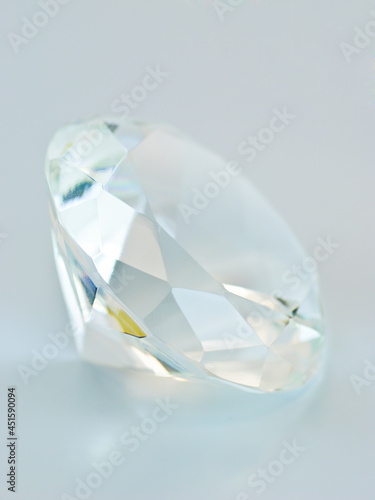 Transparent blue tinted round gemstone  lateral view