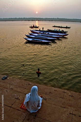 A devotee sat in a bank of river Ganges in Varanasi in the   morning. 