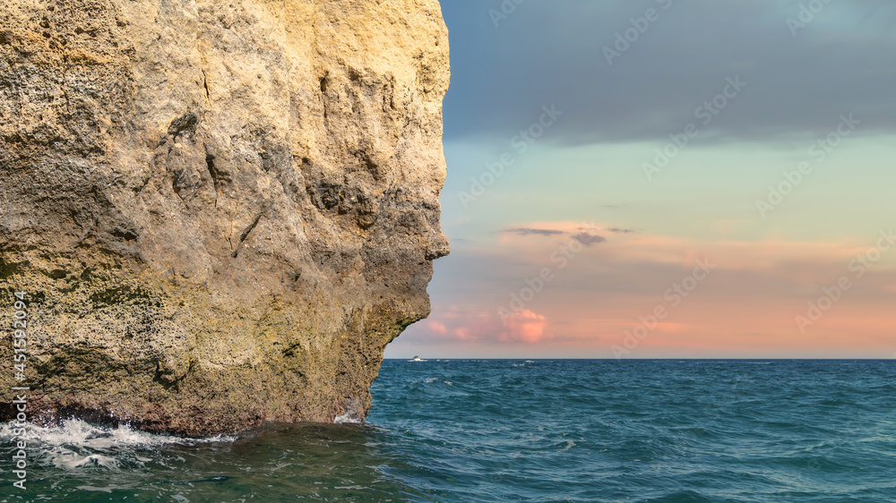 The iconic natural rock formation called the face in Praia da Marinha in Algarve, Portugal. View from popular boat cave tour along Algarve coast.