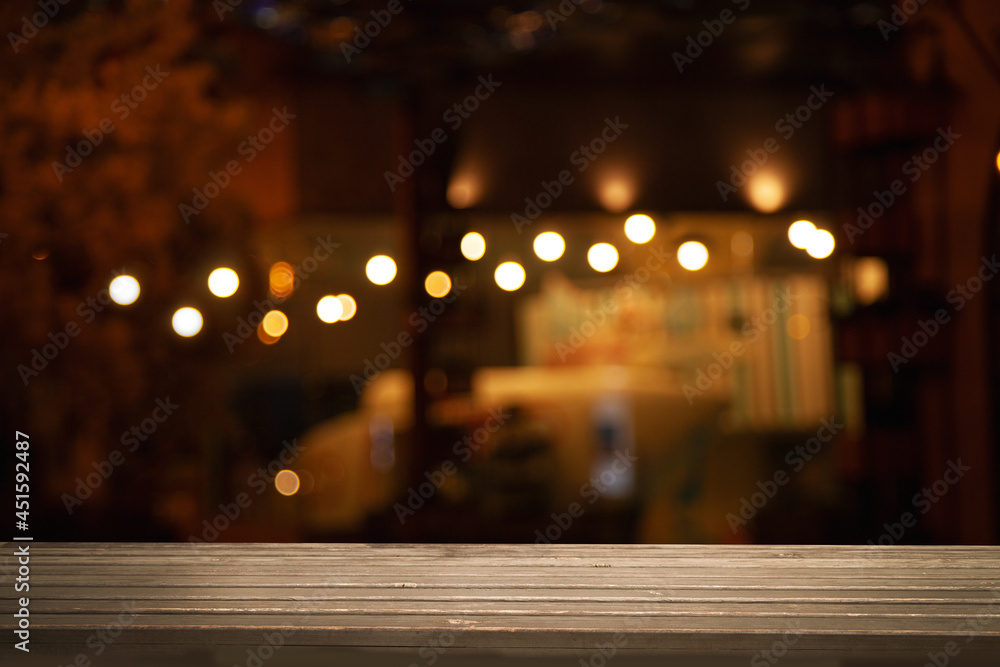 empty wooden table on blurred light gold bokeh cafe restaurant bar, place for your products on the table.