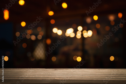 empty wooden table on blurred light gold bokeh cafe restaurant bar  place for your products on the table.