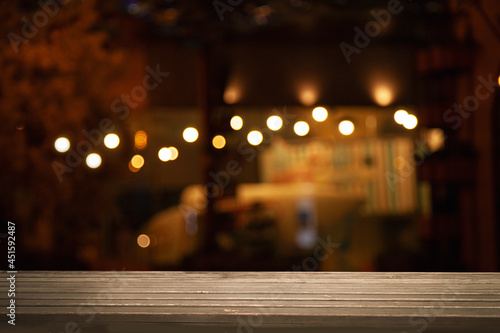 empty wooden table on blurred light gold bokeh cafe restaurant bar, place for your products on the table.