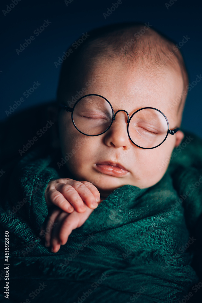 Beautiful newborn two week baby boy photo in studio with cute eyeglasses. Beautiful newborn two week baby boy photo in studio with cute eyeglasses.