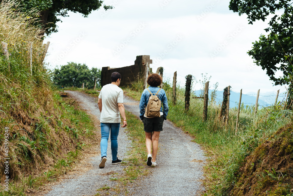 Rear view of mother and teenager son walking on rural footpath. Family and activity concepts Rear view of mother and teenager son walking on rural footpath. Family and activity concepts