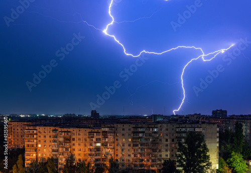 Thunderstorm with lightning above the night city