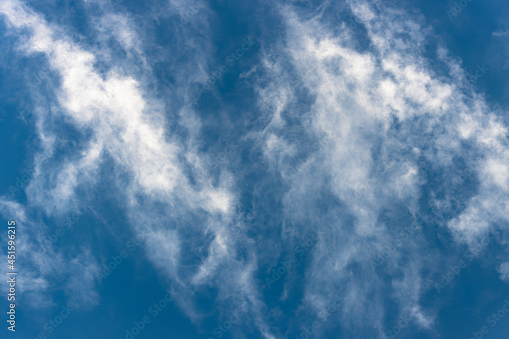Bottom view of fluffy white cloud on deep blue sky Bottom view of fluffy white cloud on deep blue sky