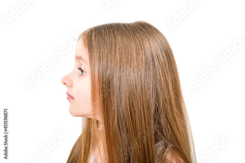 Portrait of a cute little girl, side view, isolated on white background
