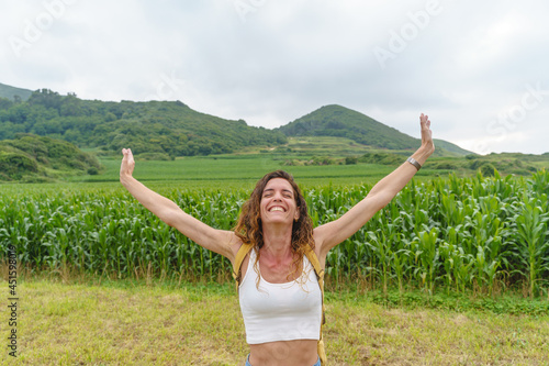 Vászonkép Free woman with arms wide open in a cornfield