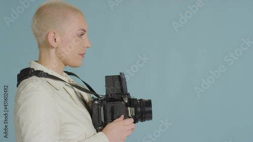 Side view of female photographer using medium format film camera 03 photo