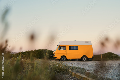 Yellow caravan parked on the parking beach