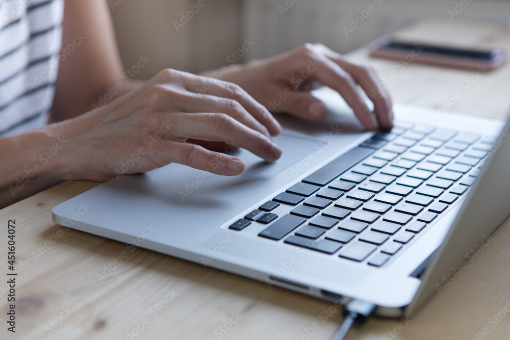 Close up of hands typing on laptop computer keyboard on table with sunlight. Close up of hands typing on laptop computer keyboard on table with sunlight.