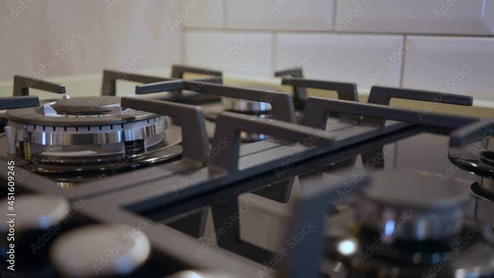 Close-up of burner on brand new gas stove in home appliances store. Household appliance indoors. Housekeeping and trading concept Close-up of burner on brand new gas stove in home appliances store. Household appliance indoors. Housekeeping and trading concept