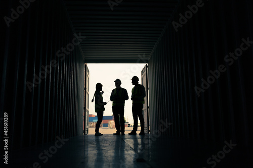 silhouette Group of staff worker standing and checking the containers box from cargo ship for export and import