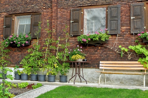 Wooden shingle facade. Old farmhouse with plants, St. Gallenkirch, Vorarlberg, Montafon, Austria
