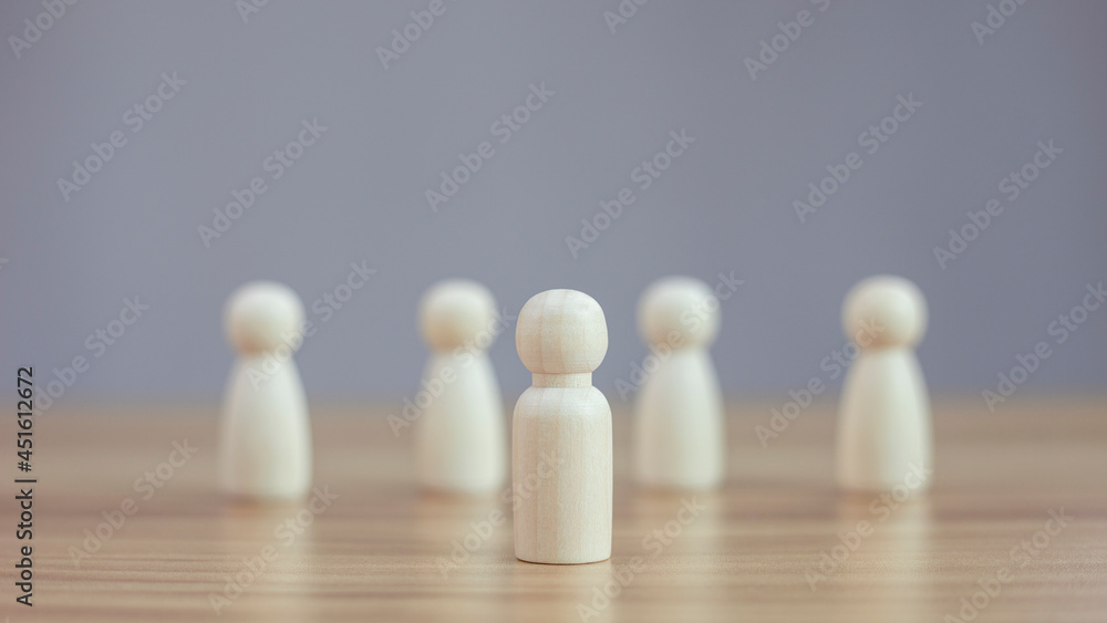 Wooden person model among blurred people on black background, Leadership concept. Wooden person model among blurred people on black background, Leadership concept.