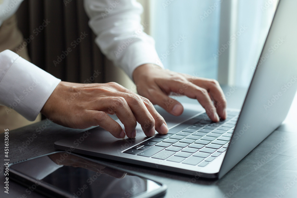 Closeup hands business working at office, Man typing keyboard on laptop or computer Closeup hands business working at office, Man typing keyboard on laptop or computer