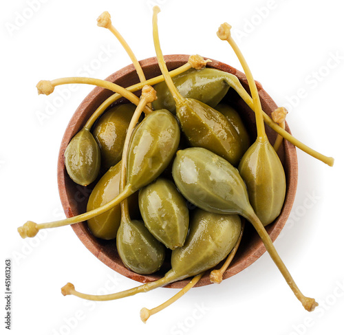 Pickled capers in a plate on a white background, isolated. Top view photo