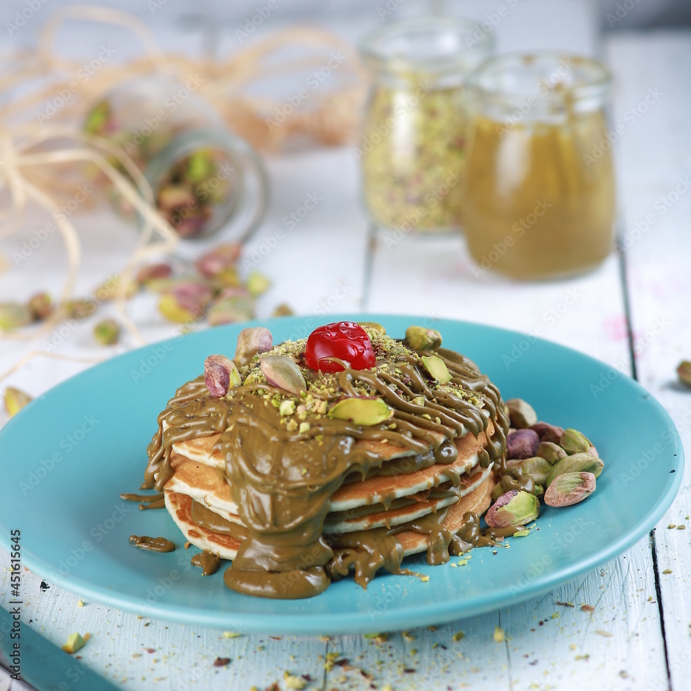 pancakes with sirup pistachio in a plate 