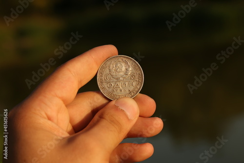 Russian silver coin one ruble in hand