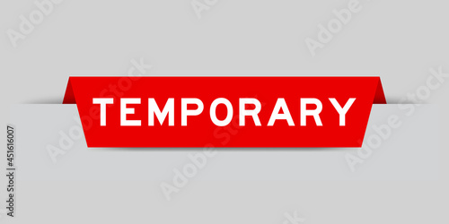 Red color inserted label with word temporary on gray background photo