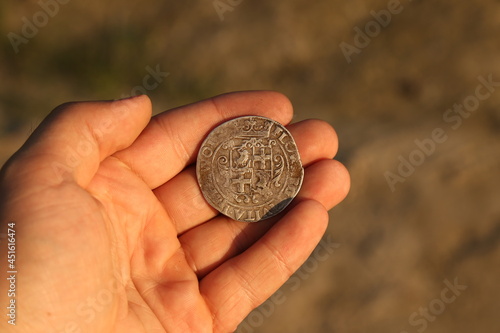 Silver medieval european coin in hand