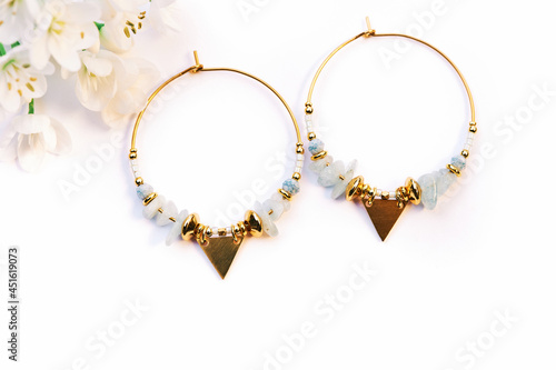 Close up image of handmade modern earrings on white background