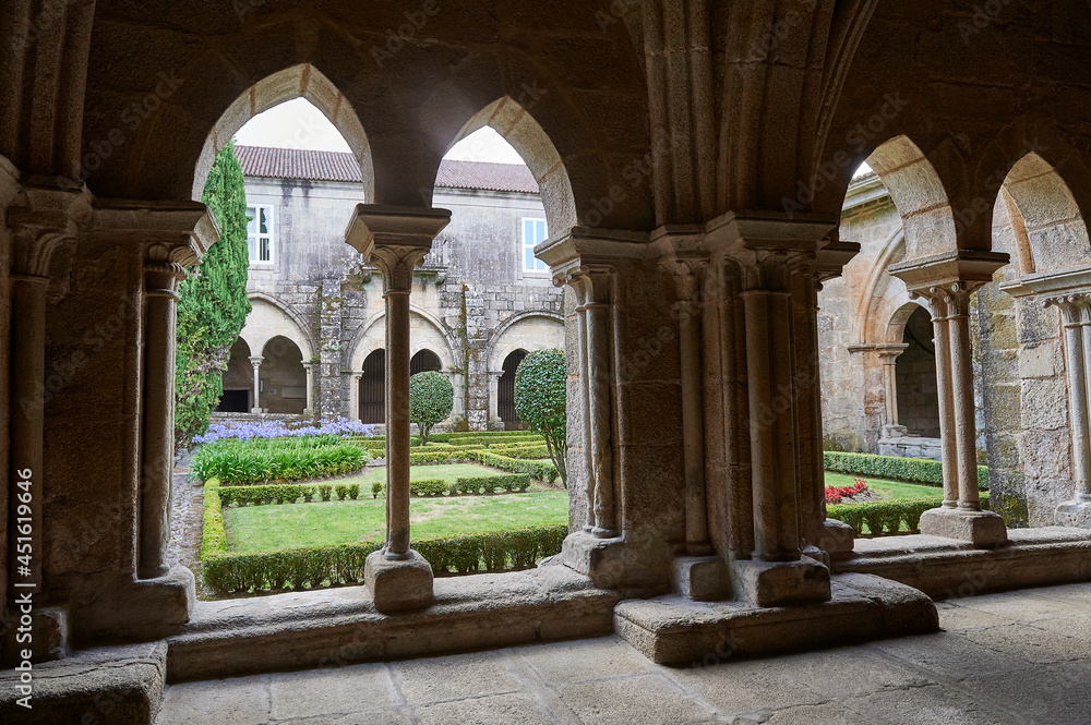 cloister with Gothic arches, columns and capitals, and interior garden ...