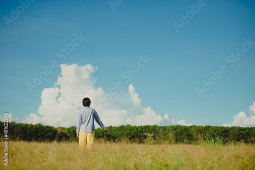Young woman beautiful woman happy at the beautiful meadow at sky background. happiness concept.