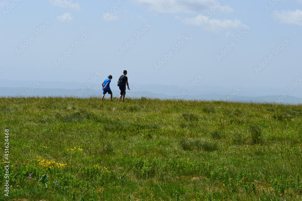 people on a hiking trail in the mountains people on a hiking trail in the mountains