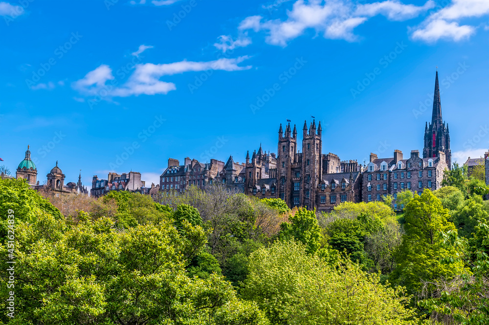 A view from Princes Street Gardens towards the buildings on the Royal Mile in Edinburgh, Scotland on a summers day