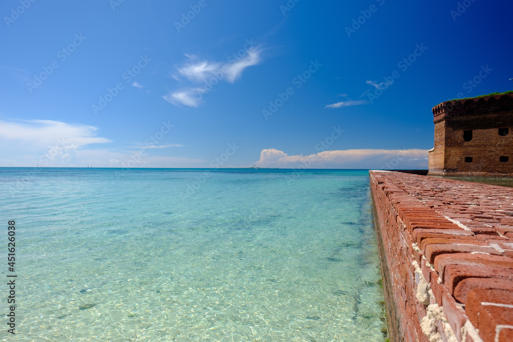 The moat wall built around Fort Jefferson in the Gulf of Mexico and the crystal clear waters of the Gulf The moat wall built around Fort Jefferson in the Gulf of Mexico and the crystal clear waters of the Gulf