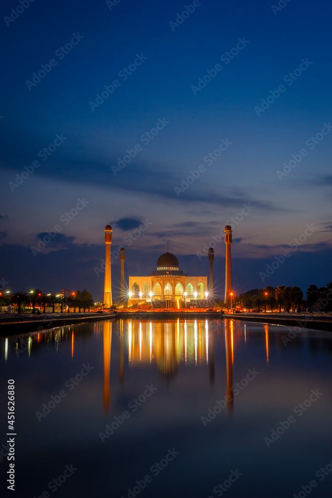 The lights in front of the Central Songkhla Mosque  reflect the water at twilight