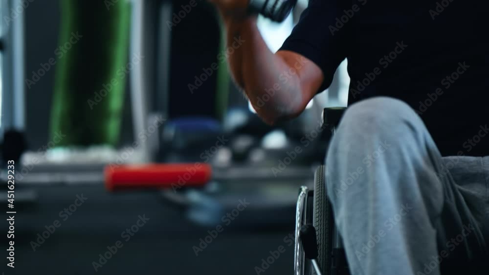 Elderly disabled man is doing exercises to strengthen his arm muscles Elderly disabled man is doing exercises to strengthen his arm muscles