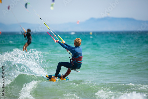 young boy practicing kite surfing