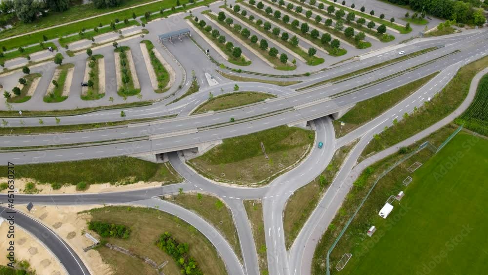 Aerial of roundabout low traffic , motorway in Regensburg Germany Europe in 4k, intersection with exit, slip road to parking lot, few cars, drone Aerial of roundabout low traffic , motorway in Regensburg Germany Europe in 4k, intersection with exit, slip road to parking lot, few cars, drone