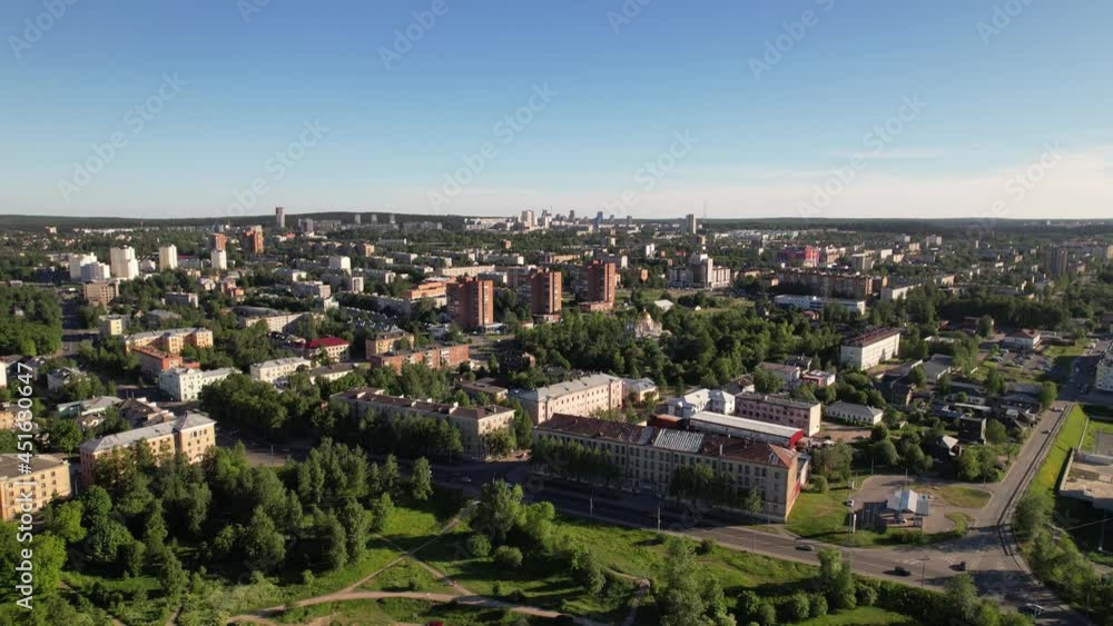 Sunny day cityscape flight. Small town aerial view with cars, houses and clear blue sky. Colorful panorama with beautiful sun beams and city roofs. Flying above the roads and apartment buildings. Sunny day cityscape flight. Small town aerial view with cars, houses and clear blue sky. Colorful panorama with beautiful sun beams and city roofs. Flying above the roads and apartment buildings.