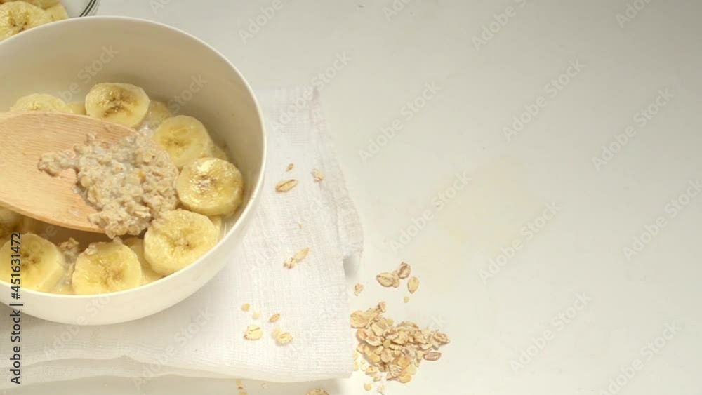 Review of a bowl of oatmeal porridge with banana slices. Review of a bowl of oatmeal porridge with banana slices.