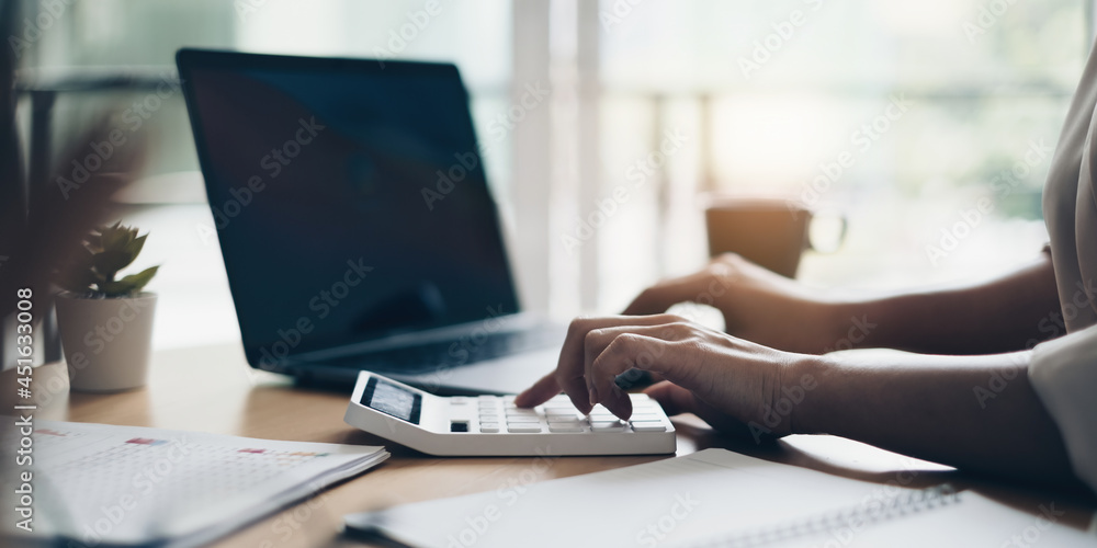 Accountant calculating and handling finances. The concept of a budget, tax, and loan paper Accountant calculating and handling finances. The concept of a budget, tax, and loan paper