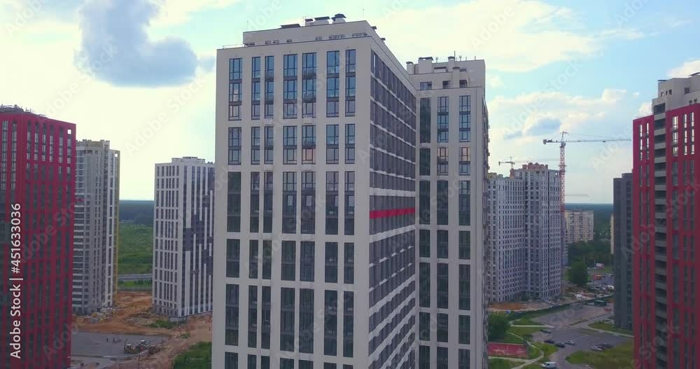 Drone view of New modern high-rise residential complex in a residential area. colorful red and white houses. Aerial drone view Drone view of New modern high-rise residential complex in a residential area. colorful red and white houses. Aerial drone view