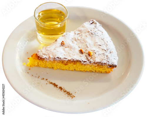 Traditional spanish almond pie Tarta de Santiago with glass of drink. Isolated over white background